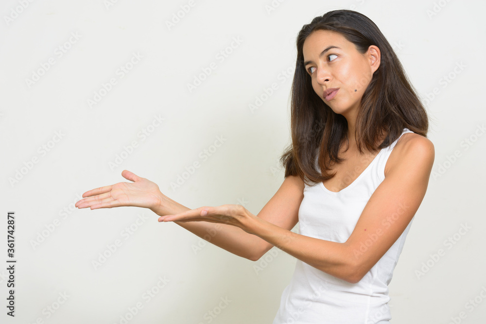 Portrait of beautiful multi ethnic woman showing something Portrait of beautiful multi ethnic woman showing something