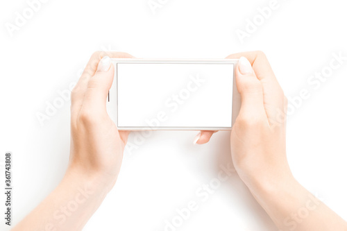 Smartphone screen. Woman holding phone in female hand with empty blank screen isolated on white background. Cellphone with space for text. Smartphone book concept.