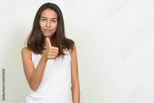 Portrait of happy beautiful multi ethnic woman giving thumbs up