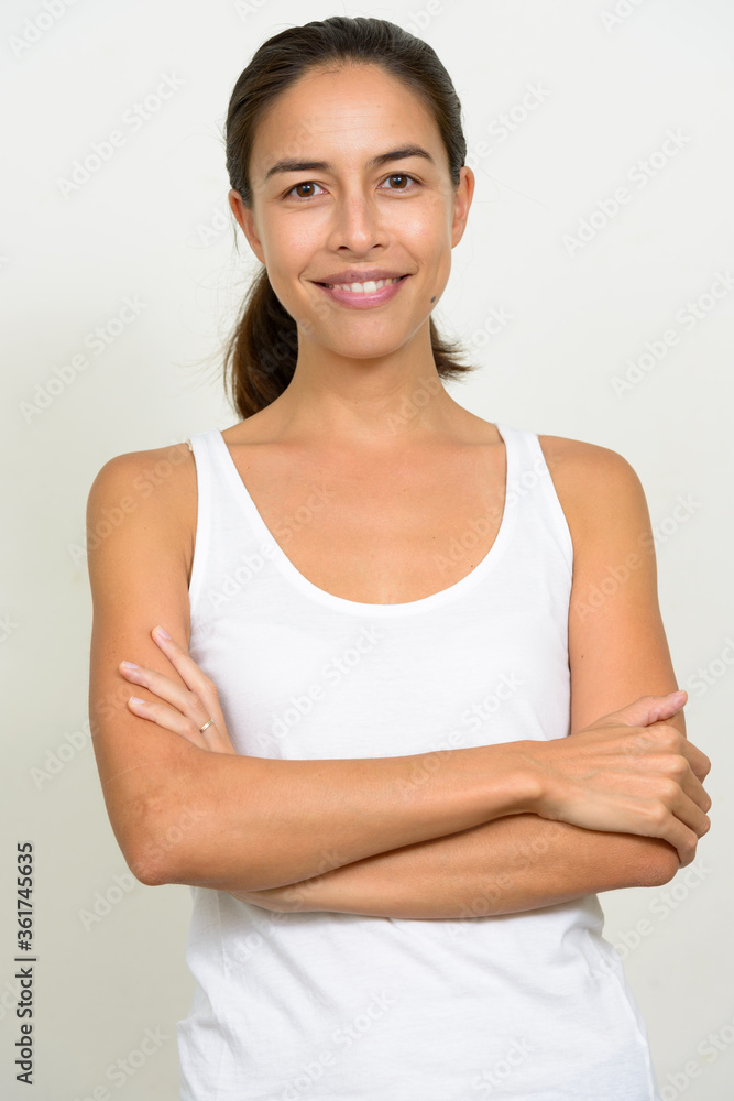 Portrait of happy beautiful multi ethnic woman smiling with arms crossed Portrait of happy beautiful multi ethnic woman smiling with arms crossed