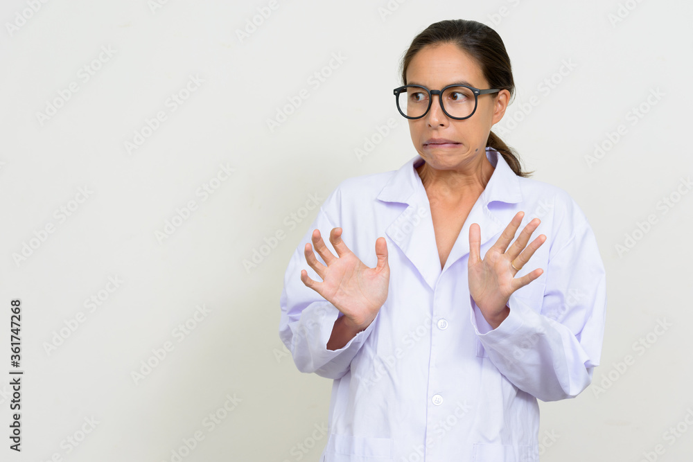 Portrait of stressed multi ethnic woman doctor looking scared Portrait of stressed multi ethnic woman doctor looking scared
