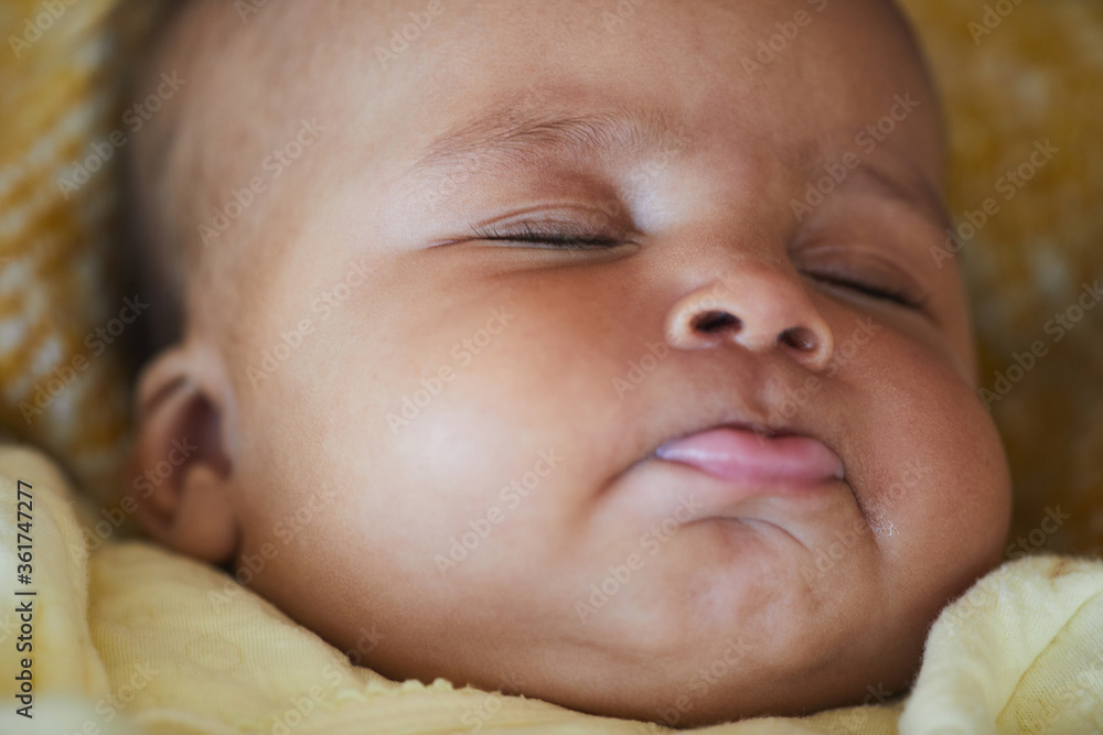 Close-up of cute African newborn sleeping in the bed Close-up of cute African newborn sleeping in the bed