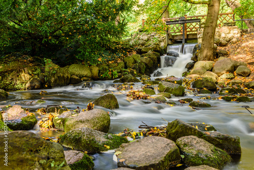 Small scenic waterfall (long exposure) in Oliwa park, Gdansk, Poland