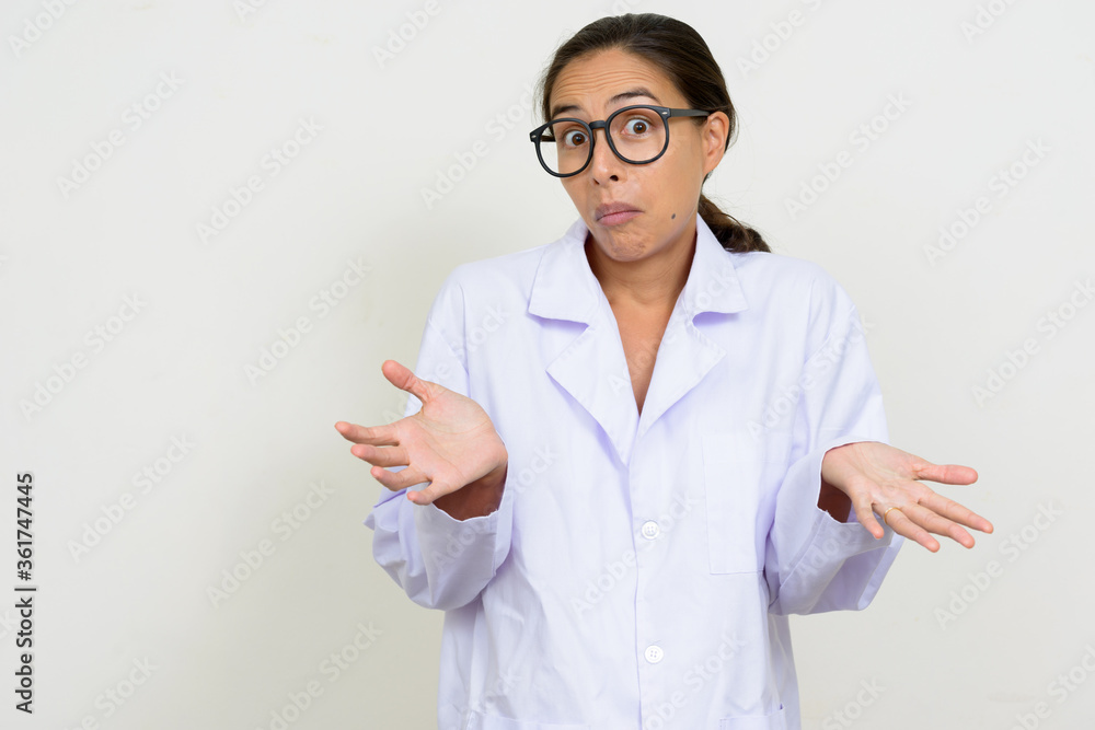 Portrait of confused multi ethnic woman doctor shrugging shoulders