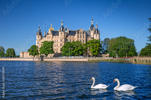 Schwerin Castle looking like a fairy tale castle surrounded by a wonderful landscape composed of lakes and forests 