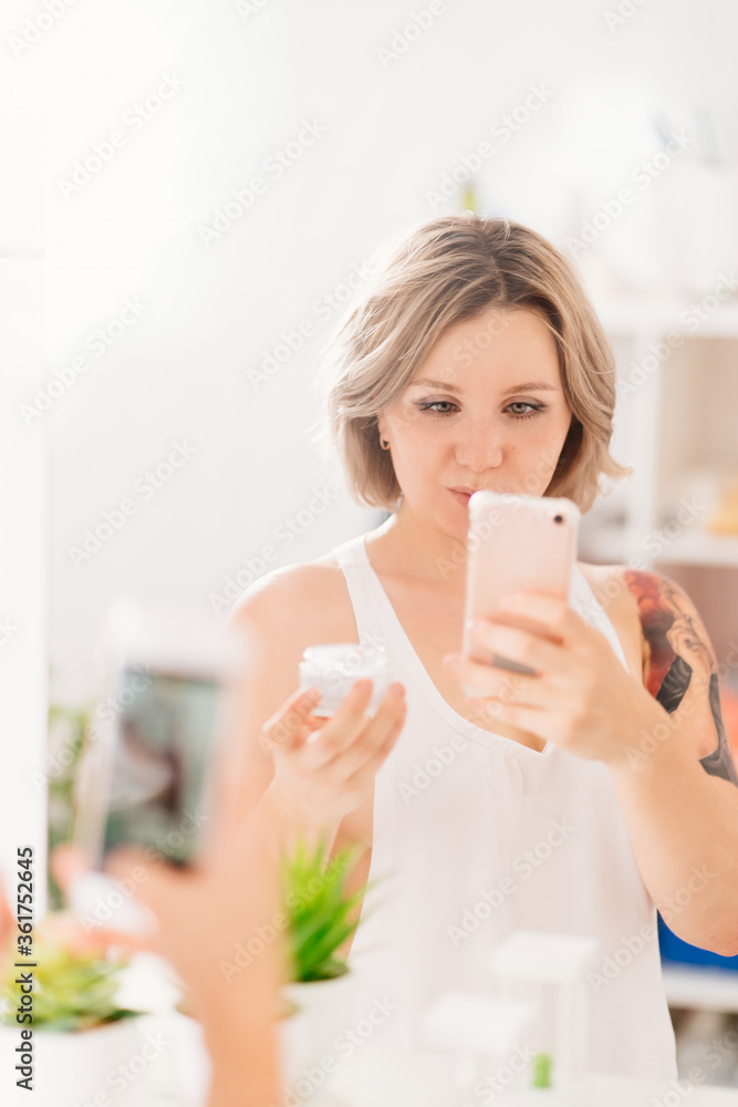 sexy girl with tattoos taking selfie photo on phone in bathroom mirror. sexy girl with tattoos taking selfie photo on phone in bathroom mirror.