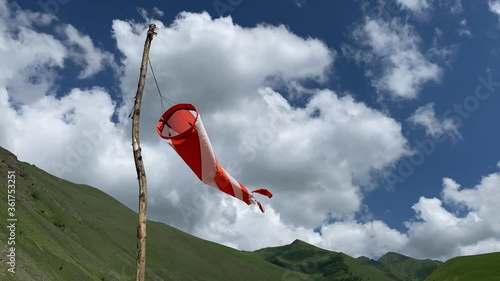 Windsock swaying in the wind at the mountains meadow