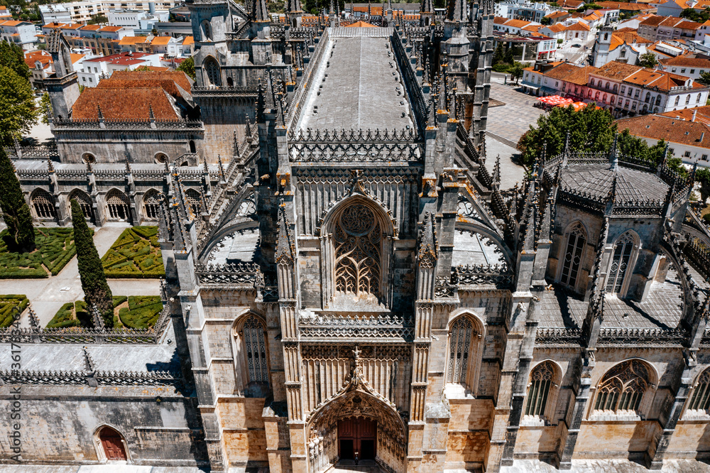 Naklejka premium Batalha, Portugal - June, 29, 2020: Aerial Drone View of Batalha Monastery. Dominican convent with manueline style architecture.