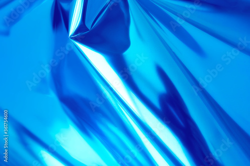 Obraz na płótnie Bright blue holographic foil background. Trendy backdrop