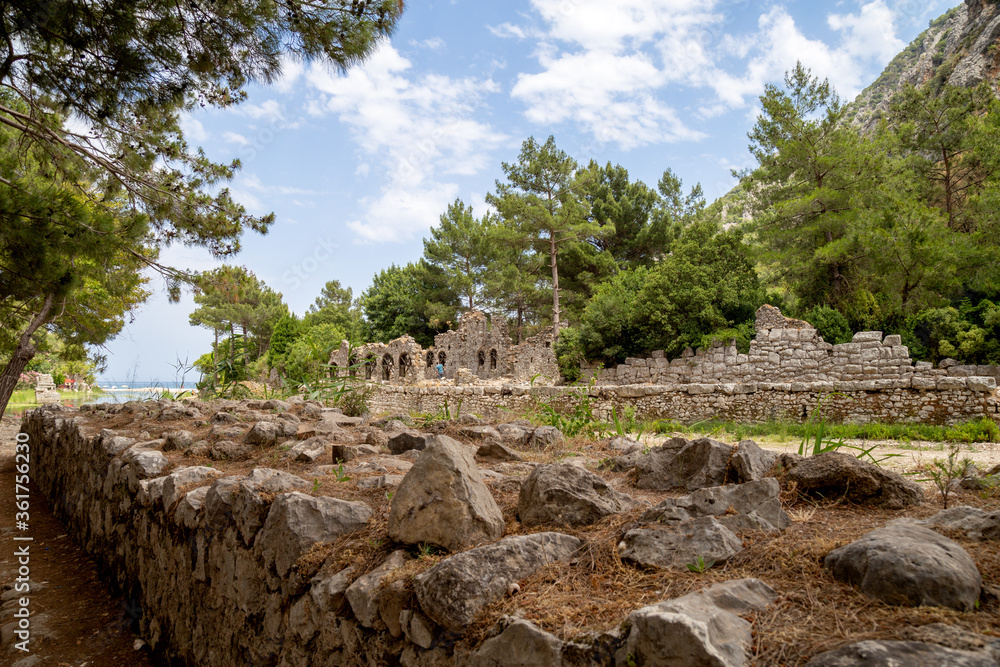 Ruins of the ancient city of Olympos in Cirali village in Antalya, Turkey.  Local and foreign tourists come to visit the ancient city and swim.