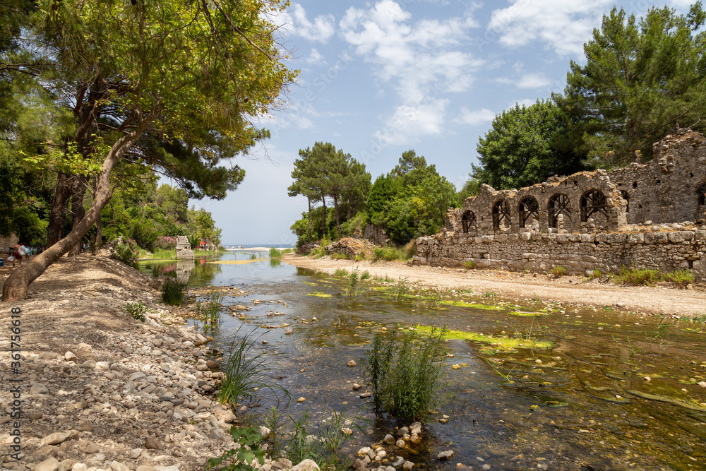 Ruins of the ancient city of Olympos in Cirali village in Antalya, Turkey.  Local and foreign tourists come to visit the ancient city and swim.