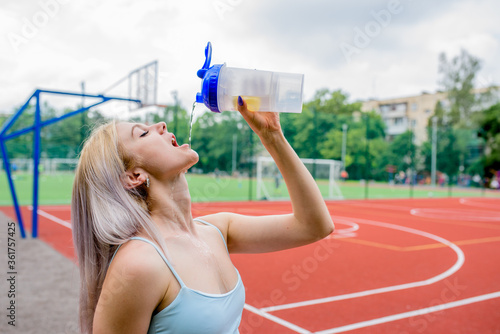 Young woman drinks water

