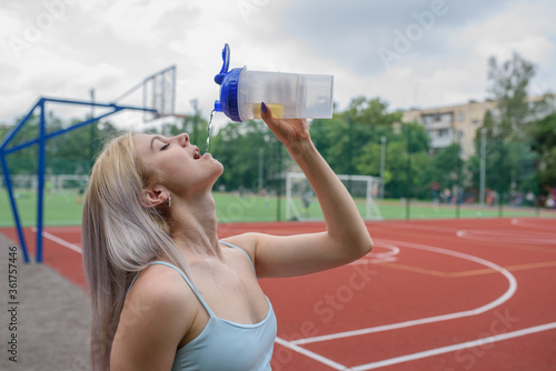 Young woman drinks water
