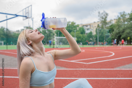 Young woman drinks water
