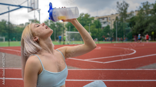 Young woman drinks water
