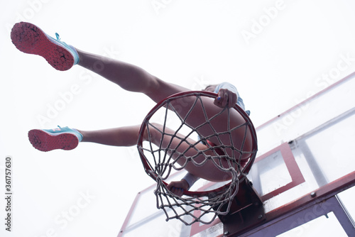  Young girl sitting on a basketball hoop © Arthur