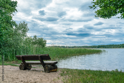 Tranquil scene with a wooden bench overlooking Wutzsee lake photo