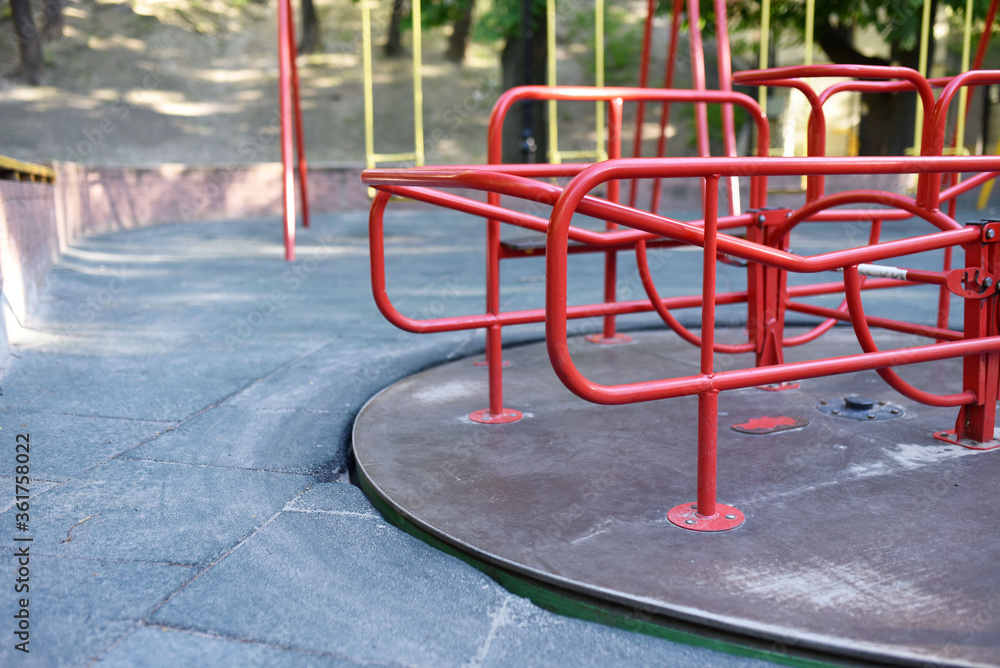 red carousel in yhe playgroung in summer red carousel in yhe playgroung in summer