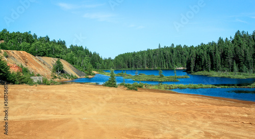 Idyllic Blue lake and forest landscape in evening sunset sunlight. Foy  Foyross Lake  Sudbury  Ontario  Canada.