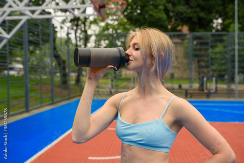 Young girl drinks from a bottle