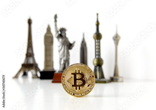 Bitcoin concept, cryptocurrencies. World economy concept. Golden coin bitcoin and souvenir from around the world. photo
