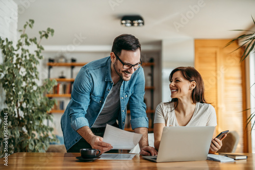 Bild auf Leinwand Portrait of successful smiling small business owners at cozy office