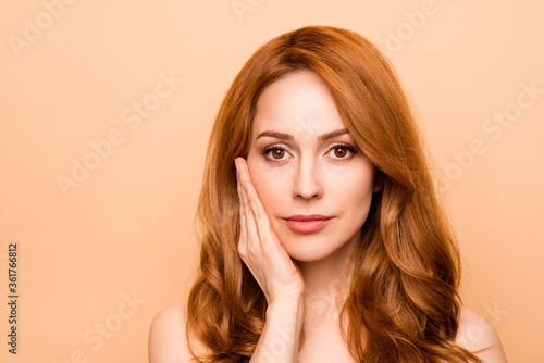 Close-up portrait of her she nice-looking attractive lovely sweet gentle shine wavy-haired lady touching cheek therapy treatment laser plastic surgery isolated over beige background