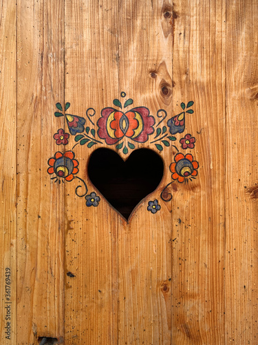 traditional heart-shaped opening on the door to a dry toilet  closeup