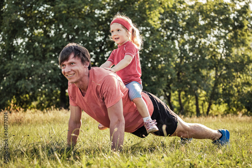 Father playing with his young daughter outdoors