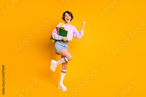 Full length body size view of her she nice attractive lovely pretty cheerful cheery glad girl having fun dancing celebrating a-mark isolated on bright vivid shine vibrant yellow color background