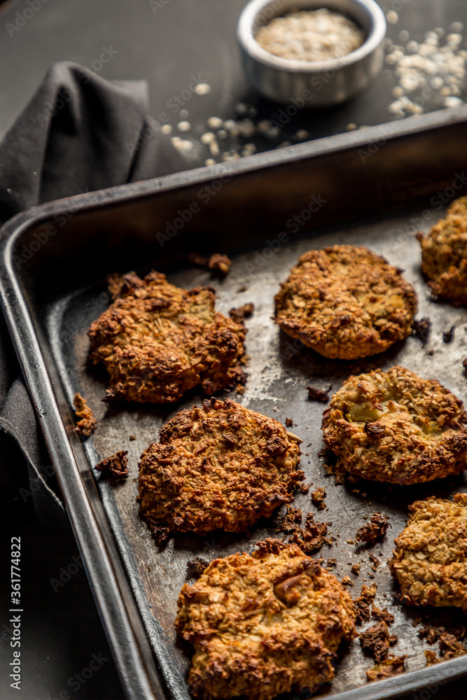 Fototapeta premium Homemade baked oatmeal cookies with dark background