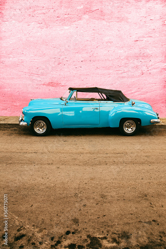 old blue car parked on pink wall, havana - cuba © livcool
