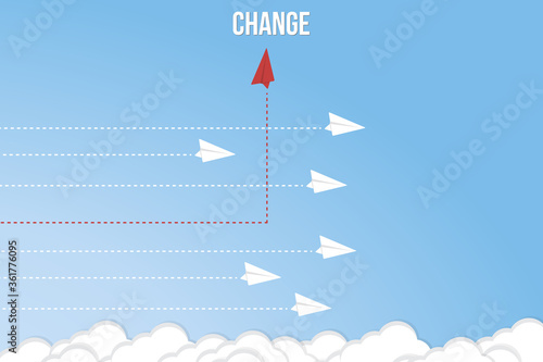 Think differently concept. Red airplane changing direction. New idea, change, trend, courage, creative solution, innovation and unique way concept. 