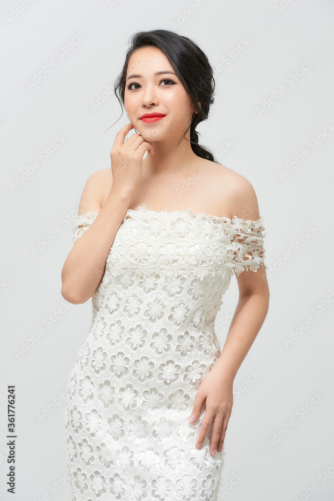 Young beautiful bride with a beautiful poses standing on white background. Young beautiful bride with a beautiful poses standing on white background.