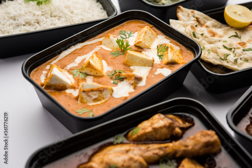 Online food delivery business concept for Indian Restaurant showing plastic containers with veg and non-veg food photo