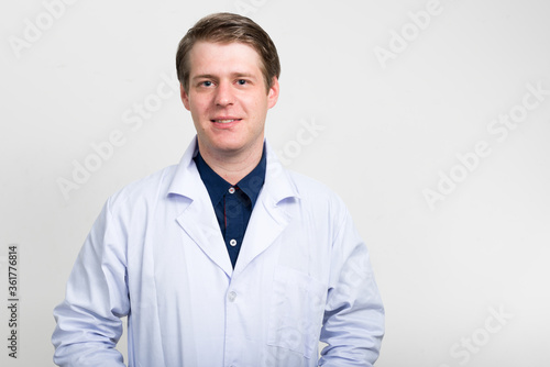Portrait of happy young handsome man doctor smiling