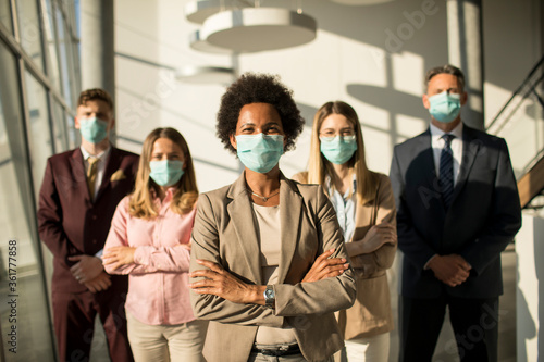 Group of asian business people standing in office and wear mask for protect prevent infection by corona virus