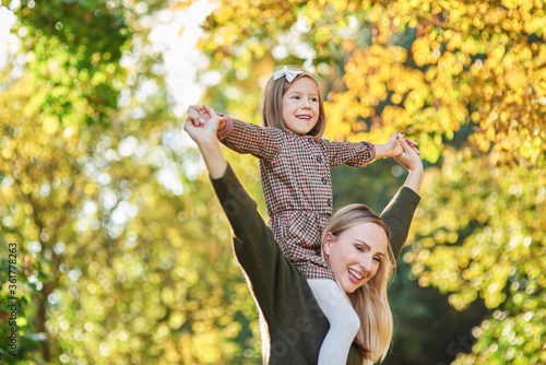 Happy girl having fun with mommy on fresh air