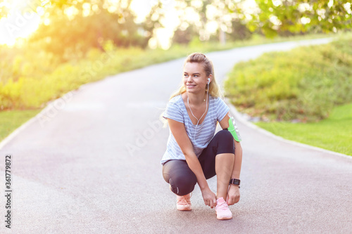 Young woman tie shoelace before jogging