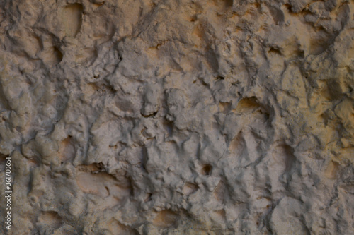 Blurred abstract background. Rough brown surface of cement wall. Old painted wall with cracks. Horizontal, closeup, free space. Construction and design concept.