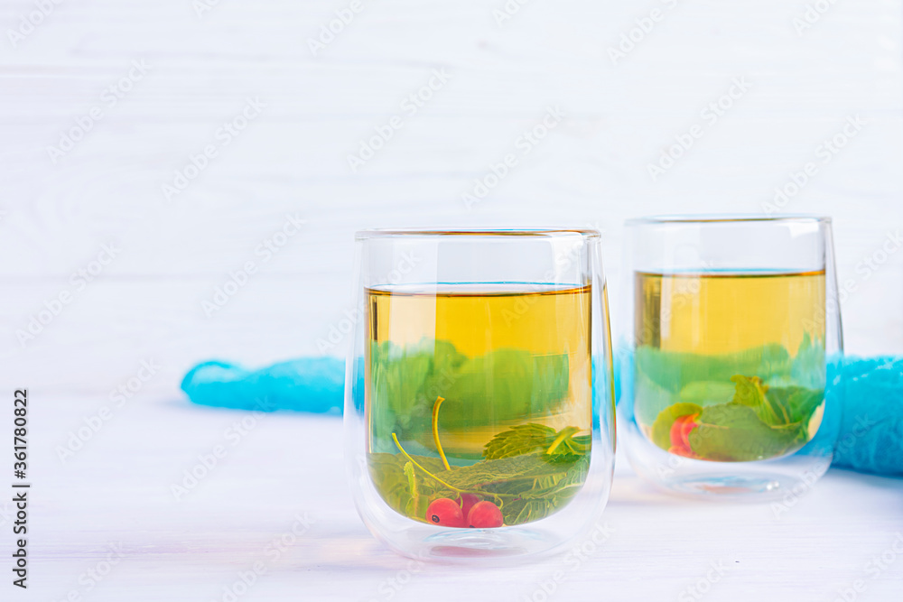 Glass cup with berry green tea and mint. Glass cup with berry green tea and mint.