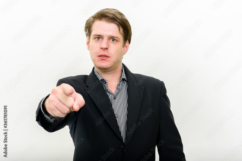 Portrait of stressed young businessman pointing at camera Portrait of stressed young businessman pointing at camera