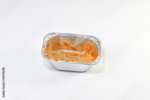 Silver foil food box contaminated on a white background