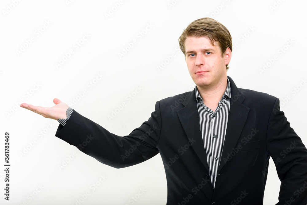Portrait of young handsome businessman showing something Portrait of young handsome businessman showing something