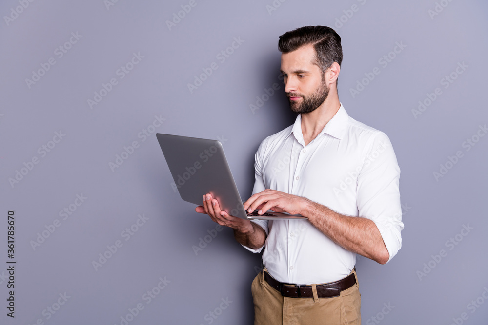 Portrait of his he nice attractive trendy focused skilled brunet guy employer using digital laptop hiring employees recruiting web search research hr isolated over gray pastel color background Portrait of his he nice attractive trendy focused skilled brunet guy employer using digital laptop hiring employees recruiting web search research hr isolated over gray pastel color background