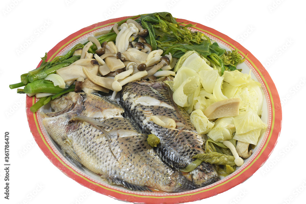 Steamed fish with vegetables isolated on a white background Steamed fish with vegetables isolated on a white background