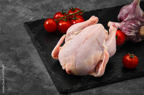 Fresh chicken carcass on a gray background, fresh meat, copy space, photo for grocery stores. dark background
