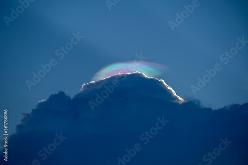 Rainbow clouds over a thundercloud in the evening