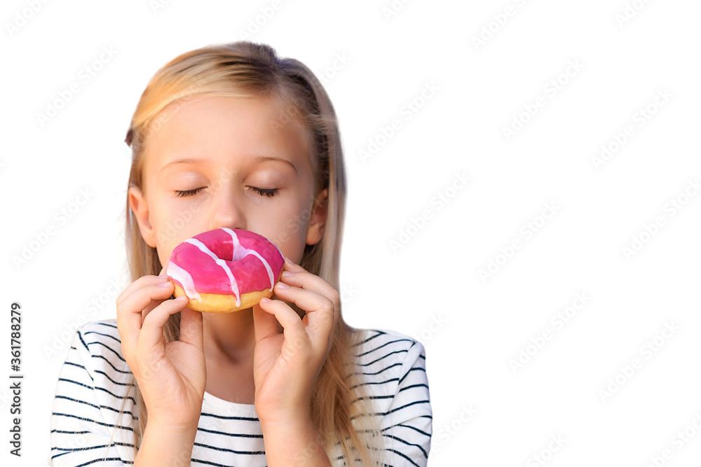 A cute little schoolgirl is enjoying a donut, a blonde of 9 years old closed her eyes in pleasure and waiting for a donut with pink icing isolated on a white background. The concept of tasty and junk A cute little schoolgirl is enjoying a donut, a blonde of 9 years old closed her eyes in pleasure and waiting for a donut with pink icing isolated on a white background. The concept of tasty and junk