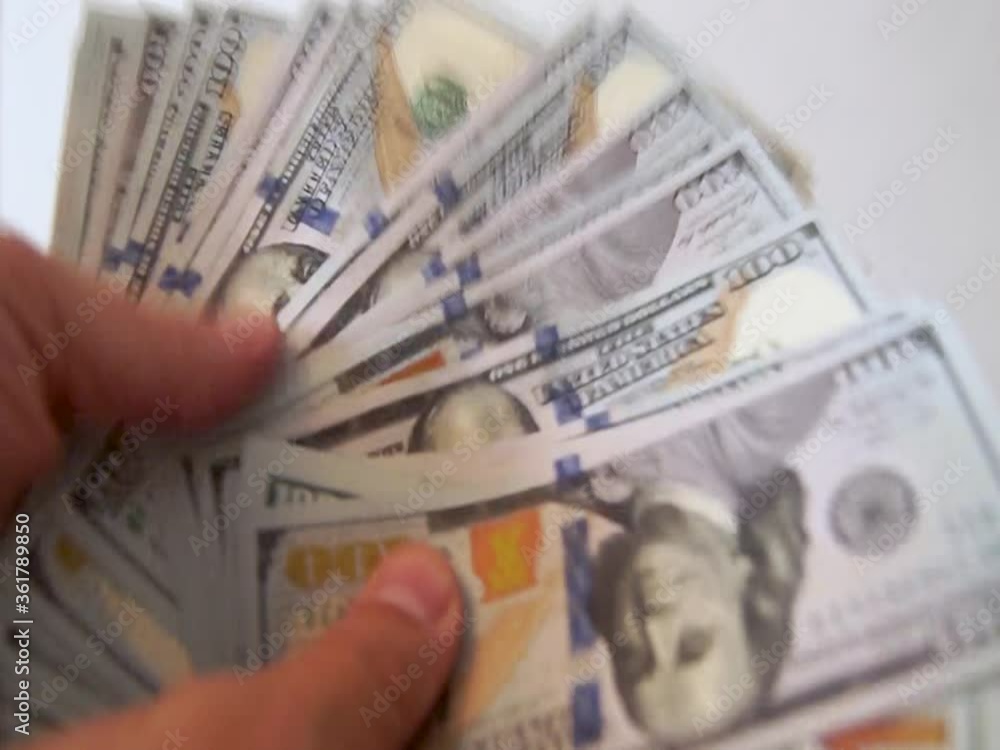 Hands of counting and transferring dollar bills or paying in cash on a white background. Concept for investment, success, financial prospects or career growth. Hands of counting and transferring dollar bills or paying in cash on a white background. Concept for investment, success, financial prospects or career growth.